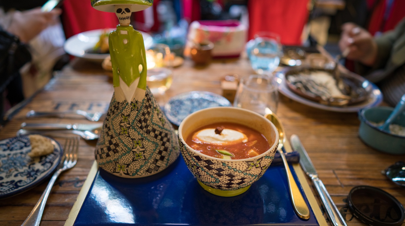 Ultra close-up macro food photography of creamy chicken tortilla soup with cilantro and tortilla strips